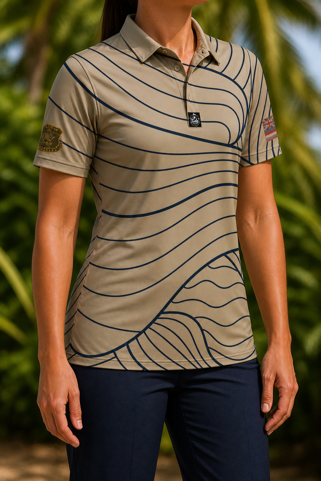 Tan and navy HIANG 80th anniversary polo worn untucked by a female model